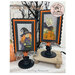 The two completed cross stitch projects of Boo and Hazel, set on a faded gray fabric and stitched with bright colors, displayed on a Paisleys and Polka Dots mount.