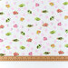 Tula Pink School Crossing TPU vinyl featuring schools of colorful fish in an underwater-inspired design with a ruler to show length.