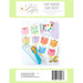 Back of the pattern showing quilt blocks staged with needle minders and a rotary cutter.