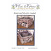 Front cover of the United We Stand Sewing Box cross stitch pattern with the finished basket full of supplies and a decorative pinkeep on a wood floor.
