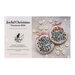 The front of the Joyful Christmas Ornaments 2026 pattern showing the completed ornaments on a swatch of gray fabric amongst scattered buttons.
