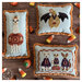 The completed cross stitch projects finished as halloween pillow and staged with candy corn and pumpkin candies