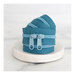 A rolled-up, teal blue zipper with two open pull tabs on top, resting on a marble surface.