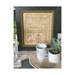 Finished Hannah Walker Reproduction cross stitch pattern in a gold ornamental frame in a kitchen household scene.