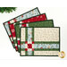 The four completed Fat Quarter Shuffle Mats, fanned out on a white table.