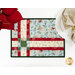 A top down close up of one of the Fat Quarter Shuffle Mats, demonstrating the Christmas fabric prints and colors; flowers and a plate with a napkin peek into frame.