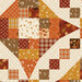Closeup of the cream cheater fabric with fall colors and motifs in a Snowball and 5440 Quilt Block design.