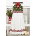 The completed Hanging Towel colored in red, green, and white fabrics from the Holiday Spirit collection by Riley Blake Designs, staged on a kitchen drawer with coordinating decor.
