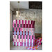 an image of two finished Ruby Sue quilts staged in a concrete room with a modern ceiling light, and a brown leather couch with a sleeping dog peeking out.