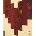 A close up on the patchwork demonstrating fabric prints, colors, and top quilting details.