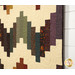 A close up on the patchwork demonstrating fabric prints, colors, and top quilting details.