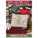 Front of the Happy Christmas Geese cross stitch pattern staged with seasonal accents and décor. 