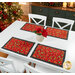 Lifestyle shot of a white dining table with the placemats placed at four chairs.