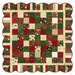 The completed Holiday Charm Quilt, colored in red, green, cream, and gold metallic fabrics from the Poinsettias at Christmas collection by Jennifer Bosworth for Riley Blake Designs, isolated on a white background. 