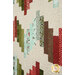 A super close up on the patchwork, showing fabric print, color, and top quilting details.