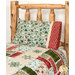 Another angle of the pillowcase, staged on a log cabin bed with a coordinating quilt.