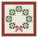 A digital mockup of the Circle of Cheer Quilt kit featuring a patchwork wreath isolated on a white background.