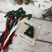 The tree lot floss drops by Primrose Cottage Stitches displayed with floss and in their packaging. 