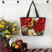 The completed tote made with a sophisticated poinsettia and bird panel, staged against a wall with coordinating flowers.