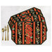 Four placemats fanned out and colored in a black and red floral vertical print, staged with gold utensils on a white background.