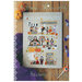 Front of the pattern displaying the finished project staged on a wooden board with candy and pumpkins.