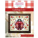front cover of the Ladybug Love cross stitch pattern featuring a stylized ladybug surrounded by red and orange florals.