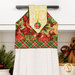 A close up on the top section of the towel, showing details on the ornament fabric as well as the fabric button.
