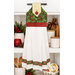 The completed Hanging Towel colored in cream, red, and green fabrics from the Deck the Halls collection by Northcott Fabrics, staged on a kitchen drawer with coordinating decor.