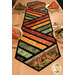 An angled shot of the runner, demonstrating beautiful patchwork layout and fabric colors.