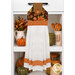 The completed Hanging Towel Kit colored in autumn fabrics from the Bountiful collection by Riley Blake Designs, hung on a drawer surrounded by coordinating décor.