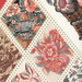 an 8x8 swatch of the panel featuring an up close shot of a few floral diamonds with the polka dot trim and a corner of the basket bouquet