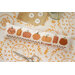 The front of the pattern, showing the finished project displayed on an autumally-themed tabletop.