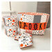 The finished panel project: a tote basket that says "spooky," staged with a dessert roll and three mini charm packs.