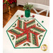 The completed 60 Degree Diamond Table Topper colored in cream, red, and green fabrics with gold metallic accents from the Adorn collection by Andover Fabrics, staged on a white table with coordinating décor.
