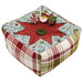 A angled shot of the Folded Star Pin Cushion Kit with the three included clay pins, colored in wintry prints from the Chilly collection by Moda Fabrics, beside the three clay pins, isolated on a white background. 
