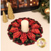 The completed Fold'n Stitch Blooms topper colored in black, red, and cream fabrics with gold metallic accents from the Merry Christmas 2026 collection by Timeless Treasures, staged on a cream table with coordinating décor and a candle at the center.