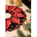 The completed Fold'n Stitch Blooms topper colored in black, red, and cream fabrics with gold metallic accents from the Merry Christmas 2026 collection by Timeless Treasures, staged on a cream table with coordinating décor and a candle at the center.