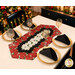 A top down shot of the runner, staged with coordinating gold table settings, wine glasses, and black napkins.