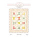 front cover of the Sunrise Pattern featuring a colorful star blocks set among soft patchwork squares, with a floral border and scalloped edge