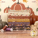 A stack of the fabrics included in the Autumn Rising collection, with the included panel and pumpkins and a rabbit and thread.