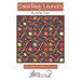 front cover of the Swirling Leaves quilt pattern cover featuring the finished leaf quilt quilt.