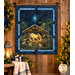 The completed Peace & Harmony Panel Quilt, colored in blue fabrics and a panel from the Peace & Harmony collection by Timeless Treasures, hung on a rustic wood paneled wall and staged with coordinating décor.