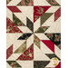 A close up on the patchwork of the quilt, demonstrating fabric colors and print details as well as top quilting effects.