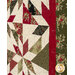 A close up on the patchwork of the quilt, demonstrating fabric colors and print details as well as top quilting effects.