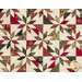 A close up on the patchwork of the quilt, demonstrating fabric colors and print details as well as top quilting effects.