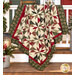 The completed Playing Favorites Quilt, colored in rich cream, red, and sage and forest green fabrics from the Candlelight Christmas collection by Moda Fabrics, artfully draped over a white porch railing and staged with understated, coordinating décor.