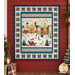 The completed Starry Night Panel Quilt, colored in unique fabrics from the Nordic Holiday Village collection by Henry Glass Fabrics, hung on a red barn wall and staged with coordinating décor.
