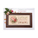 Front cover of the Rose Band Sampler with the finished pattern finished in a wooden frame next to rose bunches.