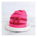 A twisted length of hot pink zipper tape with darker pink pull tabs against a marbled white background.