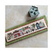 Picture of the finished pattern on a board, laid next to a handcrafted house and on top of a mottled background.